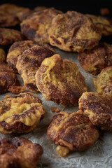 homemade mung bean sweets scattered on a tray, also known as mung kavum, traditional sweets in sri lanka, made with mung beans and rice flour, sweetened with kithul treacle, soft-focus