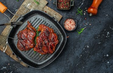 Meat grilling pork steak with herbs and spices on the grill pan. banner, menu, recipe place for text, top view