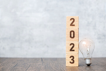 2023 block with lightbulb. Business Idea, Creative, Thinking, brainstorm, Goal, Resolution, strategy, plan, Action, change and New Year start concepts