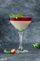 Sweet strawberry mousse with organic yoghurt. Fresh fruit dessert decorated with mint topping with strawberry sauce. Italian dessert, vertical image. top view. place for text