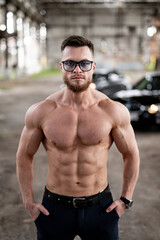 Obraz premium Young sporty muscular man with shirtless body. Handsome athletic lifestyle sexy guy.