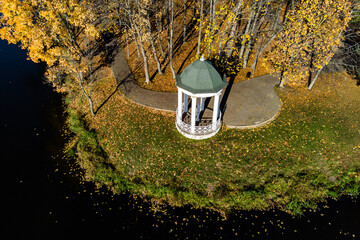 Rotunda in the autumn park on the shore of the reservoir. Belkino estate park, Obninsk, Russia