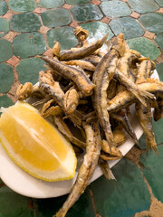 A dish of BOQUERONES FRITOS, breaded and fried fishbait, typical tapas style food in Ibiza and Spain. Balearic cuisine, crunchy and savory starter.