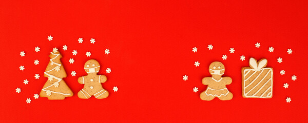 Happy New Year's 2022  set of gingerbread man in face mask from ginger biscuits glazed sugar icing decoration on classic traditional red background, minimal seasonal pandemic winter holiday banner