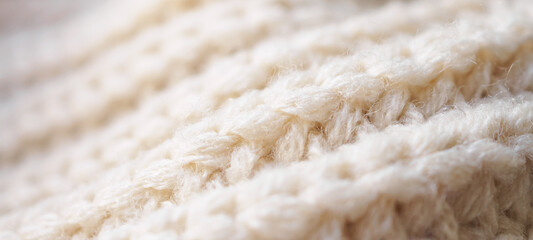 closeup beige knitted woolen fabric texture background