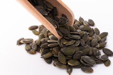 Hulled pumpkin seeds on white background
