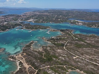 Aerial view of La Maddalena Island, Isola Giardinelli with the drone view of Caprera Island in Sardegna, Italy. Birds eye view of crystalline and turquoise water in north Sardinia, luxury yacht, boat.