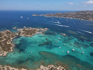 Aerial view of La Maddalena Island, Isola Giardinelli with the drone view of Caprera Island in Sardegna, Italy. Birds eye view of crystalline and turquoise water in north Sardinia, luxury yacht, boat.