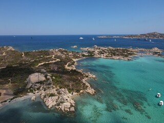 Aerial view of La Maddalena Island, Isola Giardinelli with the drone view of Caprera Island in Sardegna, Italy. Birds eye view of crystalline and turquoise water in north Sardinia, luxury yacht, boat.