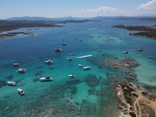 Aerial view of La Maddalena Island, Isola Giardinelli with the drone view of Caprera Island in Sardegna, Italy. Birds eye view of crystalline and turquoise water in north Sardinia, luxury yacht, boat.