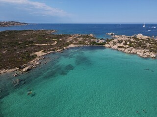 Aerial view of La Maddalena Island, Isola Giardinelli with the drone view of Caprera Island in Sardegna, Italy. Birds eye view of crystalline and turquoise water in north Sardinia, luxury yacht, boat.