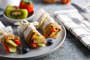 Healthy breakfast fruit rolled in a slice of bread.