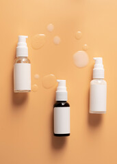 Cosmetic bottles and their contents on an orange background