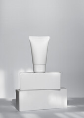 White cream tube mockup on square white boxes