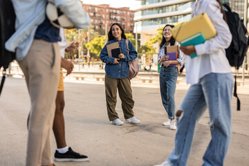 Naklejka premium Group of multiracial students meeting in front of college