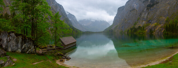 Alps mountains and lake Obersee in Summer with haze in the background, Konigsee National Park,...