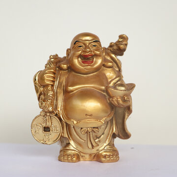 golden laughing buddha statue isolated in a white background