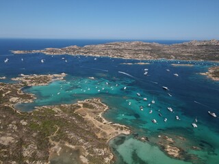 Aerial view of La Maddalena Island, Isola Giardinelli with the drone view of Caprera Island in Sardegna, Italy. Birds eye view of crystalline and turquoise water in north Sardinia, luxury yacht, boat.