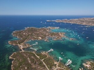 Aerial view of La Maddalena Island, Isola Giardinelli with the drone view of Caprera Island in Sardegna, Italy. Birds eye view of crystalline and turquoise water in north Sardinia, luxury yacht, boat.
