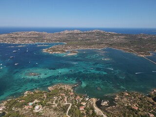 Fototapeta na wymiar Aerial view of La Maddalena Island, Isola Giardinelli with the drone view of Caprera Island in Sardegna, Italy. Birds eye view of crystalline and turquoise water in north Sardinia, luxury yacht, boat.