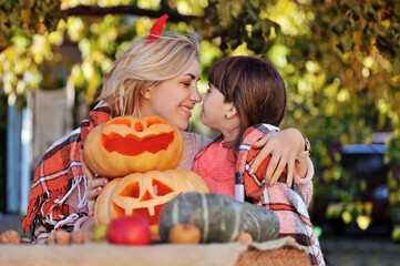 Fototapeta premium Mother hugging daughter at the Halloween party