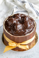 Cake with chocolate and profiteroles on a gray background. Birthday or celebration cake. close up