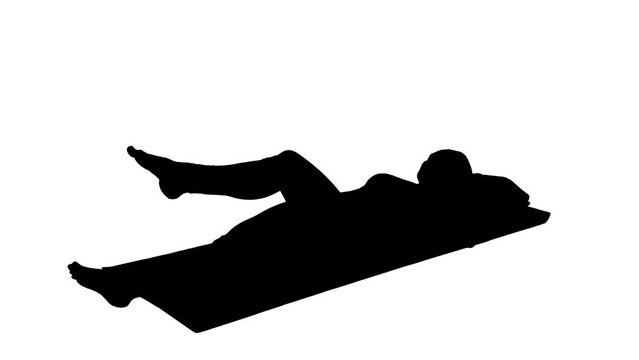 Black silhouette of woman lying and doing leg flexion and extension exercise on white background. Female is engaged in orthopedic rehabilitation or physiotherapy for pain or injury to muscles, joints.