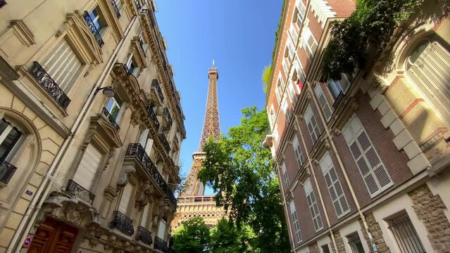 A View Of The Eiffel Tower From The Nearby Rue de l'Université Street In Paris, France. Low Angle