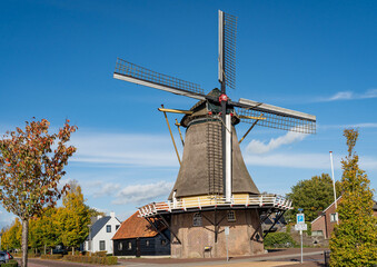 Historical dutch windmill from 1818 in the village of Dalfsen, Province Overijssel, on a sunny...