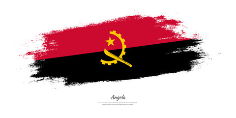 Naklejka na ściany i meble Happy Independence Day of Angola. National flag on artistic stain brush stroke background.