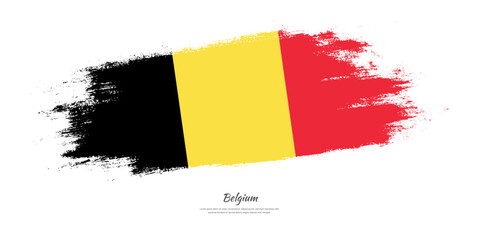 Happy National Day of Belgium. National flag on artistic stain brush stroke background.