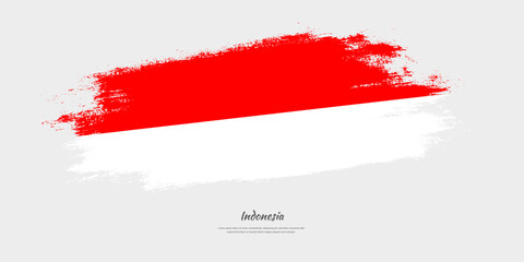 Happy Independence Day of Indonesia. National flag on artistic stain brush stroke background.
