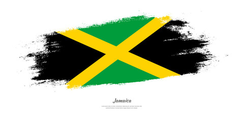 Happy Independence Day of Jamaica. National flag on artistic stain brush stroke background.