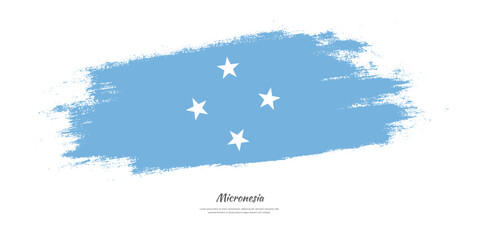 Happy Independence Day of Micronesia. National flag on artistic stain brush stroke background.