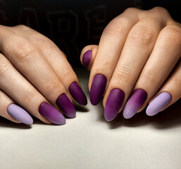 Women's manicure with purple gradient design. Beautiful lilac-purple gradient on the nails....