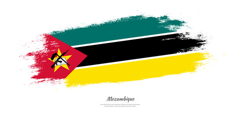 Happy Independence Day of Mozambique. National flag on artistic stain brush stroke background.