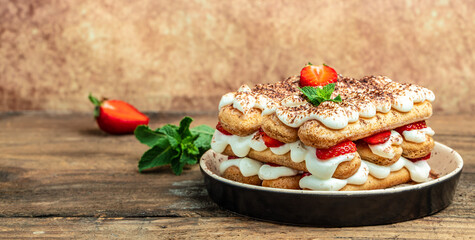 Traditional italian dessert with strawberry and mascarpone on light background. Long banner format