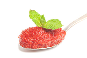 natural tomato paste with mint leaves in wooden spoon isolated on white