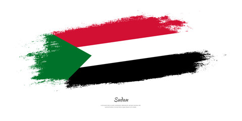 Happy Independence Day of Sudan. National flag on artistic stain brush stroke background.