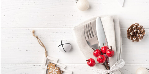 Christmas place setting on white wooden table. Copy space for text.