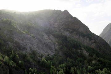 Hiking and via ferrata next to the village of Les Deux Alps, in the french Alps. There is some walking through the forest where you see structures of the old mining activities.