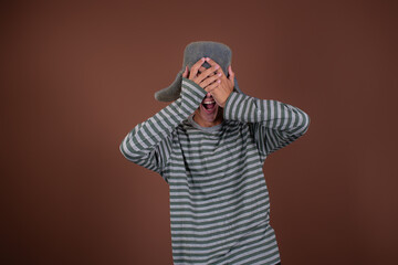 Funny man traveler. Guy on a brown background. Copy space.