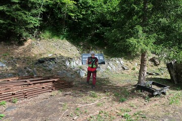 Obraz premium Hiking and via ferrata next to the village of Les Deux Alps, in the french Alps. There is some walking through the forest where you see structures of the old mining activities.