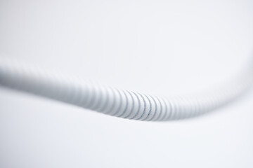 white plastic corrugated pipe on white background