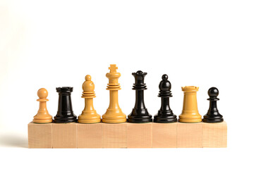 Chess pieces on wooden blocks.