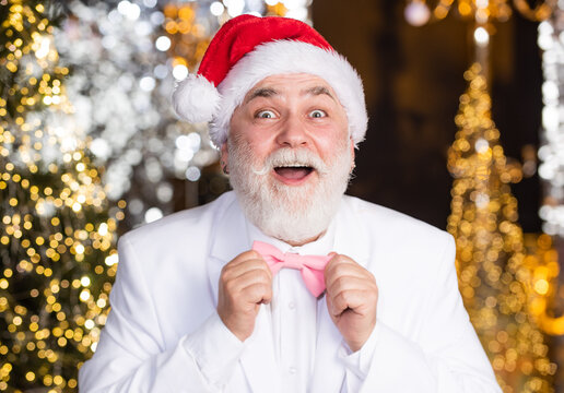 Remember these moments. happy mature man white formal suit. businessman fix event tuxedo tie. senior man santa christmas light illuminated background. bright and festive xmas mood. new year party