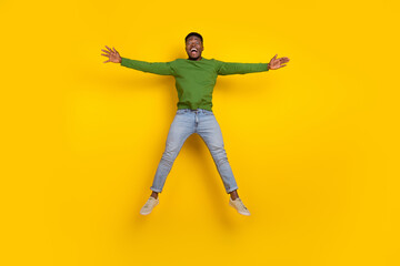Fototapeta na wymiar Full length body size view of attractive cheerful guy jumping fooling having fun isolated over vivid yellow color background