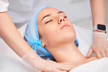Fototapeta na wymiar woman receiving facial massage at spa salon