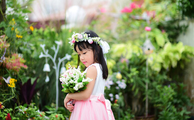 cute asian flower girl holding flowers © hwongcc