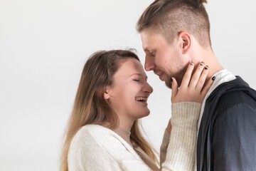 Young caucasian couple in love having fun and spending time together on white background.